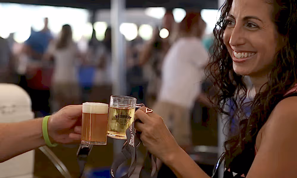 Woman holding beer sample.