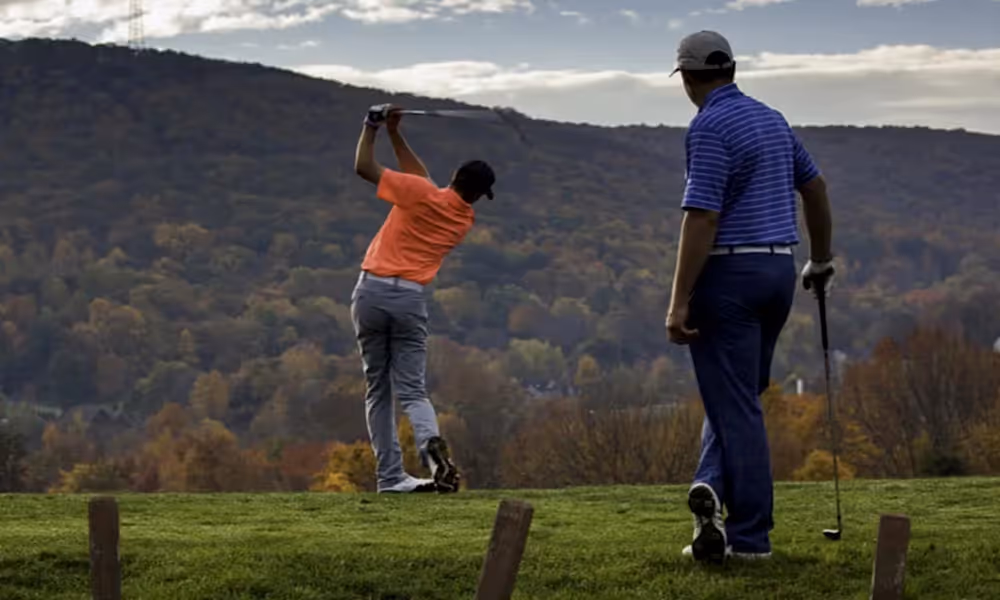 Two men playing golf at Crystal Springs Resort during Fall