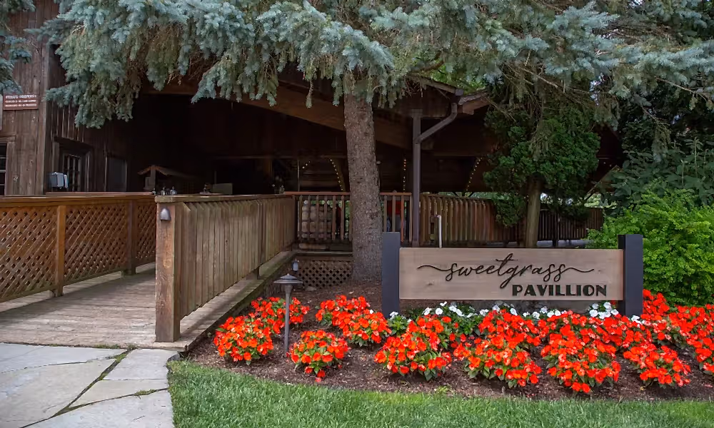 Sweetgrass Pavillion entrance with red flowers