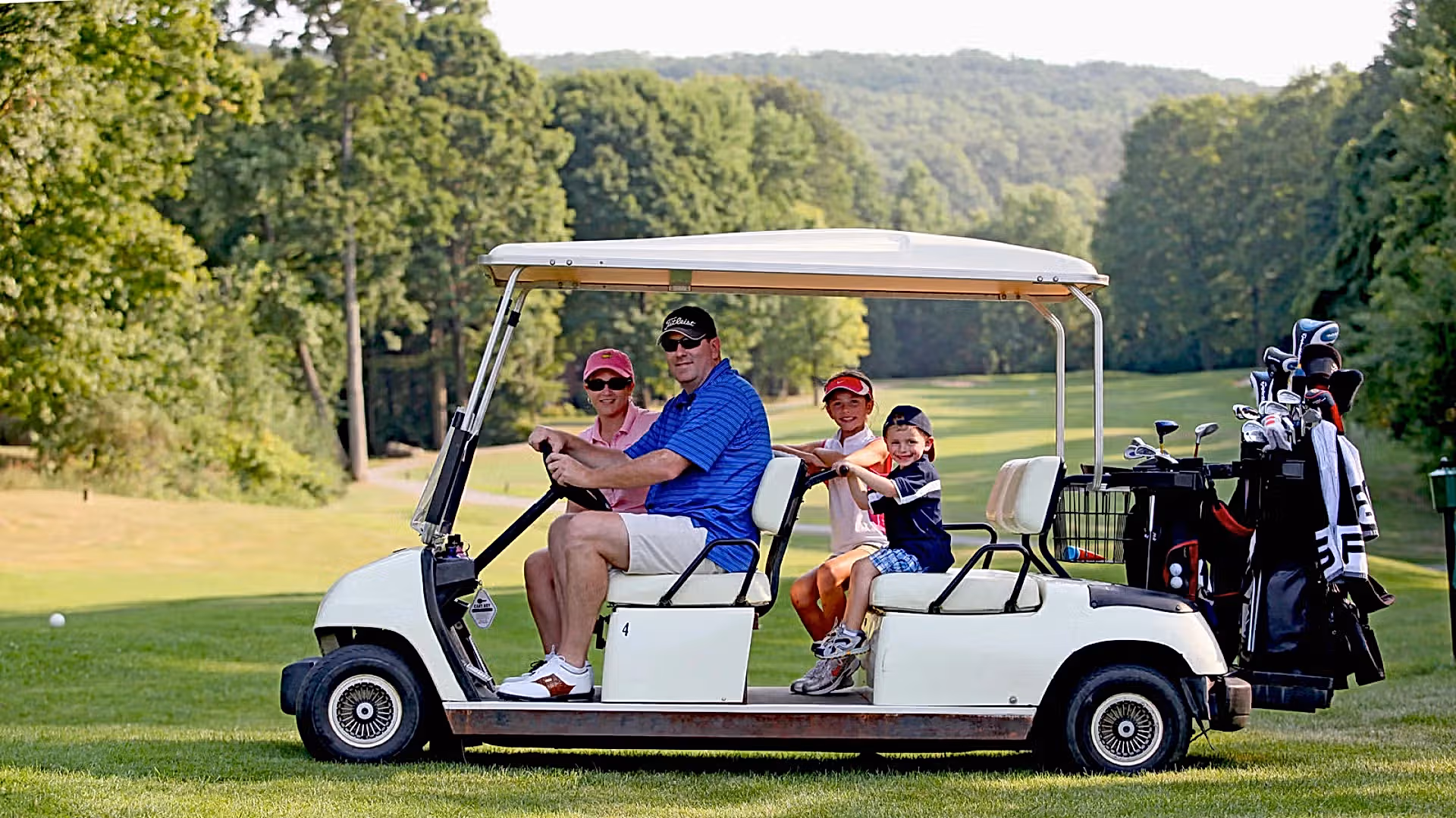 Parents with their kids on a family friendly golf course at Crystal Springs Resort in New Jersey.